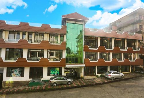 two cars parked in front of a building at Bob's N Barley in Dharamshala