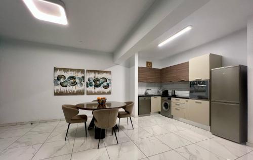 a kitchen and dining room with a table and chairs at Cosmos Residence in Paralimni