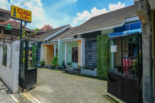 a building with a sign in front of it at RedDoorz Gita Grha Prawirotaman in Yogyakarta