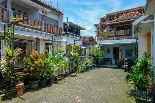 a street in a town with potted plants at RedDoorz Gita Grha Prawirotaman in Yogyakarta