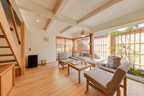 a living room with wooden floors and large windows at NIPPONIA HOTEL 伊賀上野 城下町 in Iga