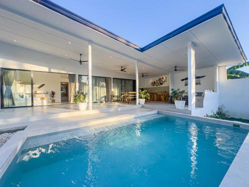 an indoor swimming pool in a house at White House Villa El Nido in El Nido