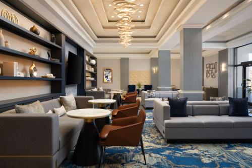 a lobby with couches and tables and chairs at DoubleTree By Hilton Baltimore North Pikesville in Pikesville
