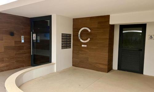 a building with wooden walls and a glass door at Cosmos Residence in Paralimni