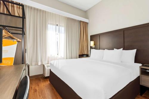 a hotel room with a large bed and a window at Comfort Suites Lumberton North in Lumberton