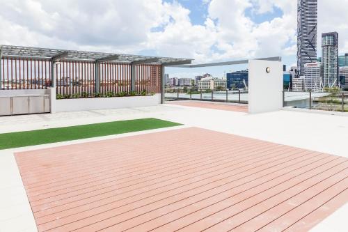 a rooftop deck with a view of the city at Fleet Lane Apartments in Brisbane