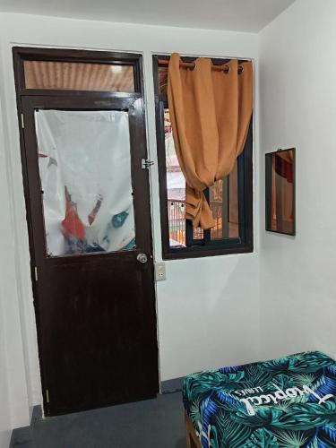 a room with a door and a window at Barnwood Homestay&cafe in Banaue