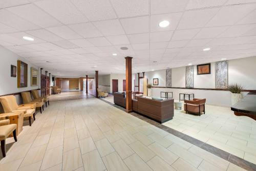 a large lobby with chairs and a waiting room at Clarion Inn & Suites and Convention Center in Kearney