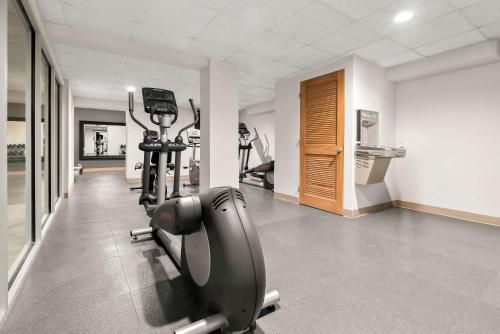 a gym with treadmills and ellipticals in a room at Clarion Inn & Suites and Convention Center in Kearney
