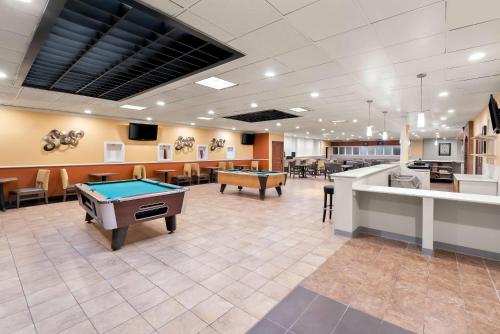 a billiard room with a pool table in the middle at Clarion Inn & Suites and Convention Center in Kearney