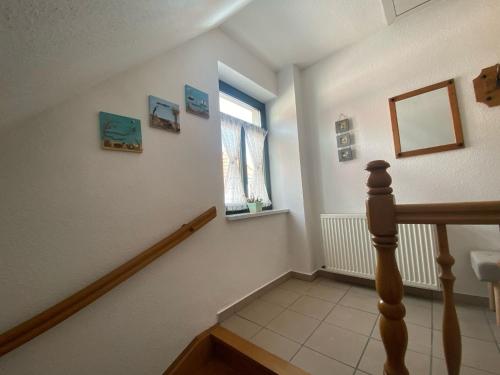a hallway with a staircase with a window at De Lütte Nest in Waren