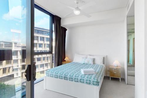 a bedroom with a bed and a large window at Urban Luxe Retreat - South Brisbane Boutique Apt w Free Carpark in Brisbane