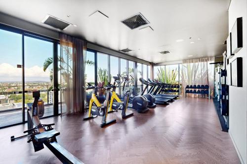 a gym with several tread machines in a room with windows at Urban Luxe Retreat - South Brisbane Boutique Apt w Free Carpark in Brisbane
