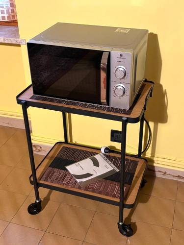 a microwave oven sitting on a shelf with a table at Valleverde in Caraglio