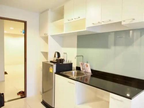 a kitchen with a sink and a counter top at The Pixel Cap Panwa Sea front Condominium - By Lovly in Ban Ao Makham