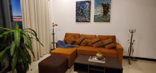 a living room with a couch and a coffee table at Luxury 32nd Floor 2 Bed-2 Bath Apartment with Pool, Harbour & Lotus Tower views in Colombo
