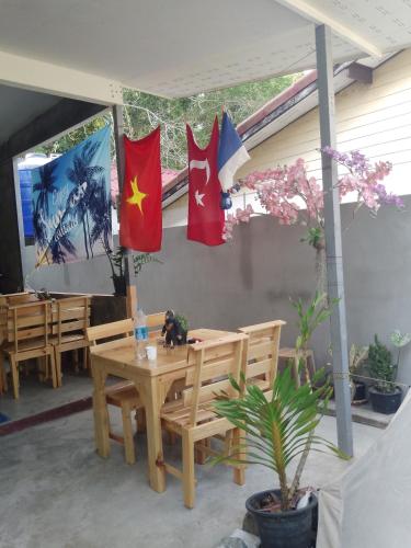 a patio with a table with flags on it at Mateoasis in Ko Kood