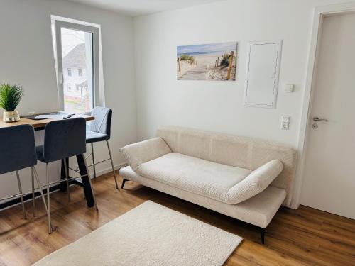 a living room with a couch and a desk at Apartment Julian in Rust