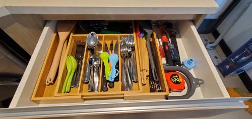 a drawer filled with utensils in a cabinet at Luxury 32nd Floor 2 Bed-2 Bath Apartment with Pool, Harbour & Lotus Tower views in Colombo