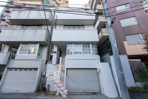 an apartment building with a set of garage doors at Y's INN 駒込 110T in Tokyo