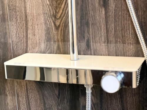 a shower head in a bathroom with a shower curtain at MD Apartments Stuttgart Zuffenhausen in Stuttgart