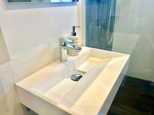 a white bathroom sink with a faucet on it at MD Apartments Stuttgart Zuffenhausen in Stuttgart