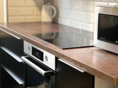 a kitchen with a counter top with a microwave at MD Apartments Stuttgart Zuffenhausen in Stuttgart