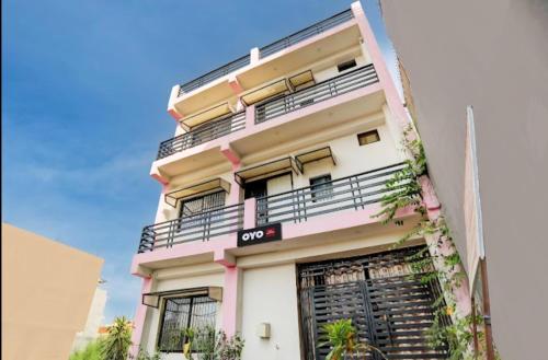 an apartment building with balconies and plants at Hotel Suryawanshi in Nilmatha