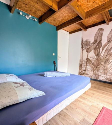 厄唐萨雷Kaz de pêcheur Les Bains的蓝色墙壁间的一张床位