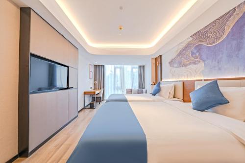Postel nebo postele na pokoji v ubytování Yunfei Hotel - Shanghai Hongqiao Wuzhong Road Branch