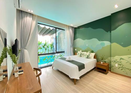 a bedroom with a bed and a large window at The Local Villa Danang in Da Nang