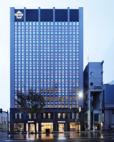 a large building with a sign on the front of it at the square hotel KANAZAWA in Kanazawa