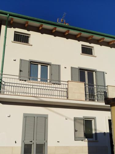 a white building with windows and a balcony at La Chioma di Berenice in Celano