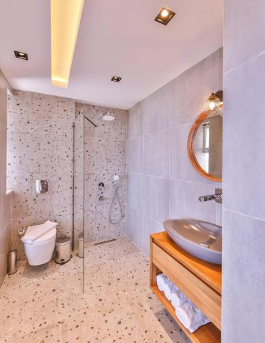 a bathroom with a sink and a shower at Villa Melissa Kaş Peninsula in Kaş