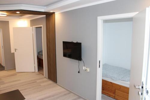 a room with a flat screen tv on a wall at Ferienwohnung Ostsee F414 in Schönberg in Holstein