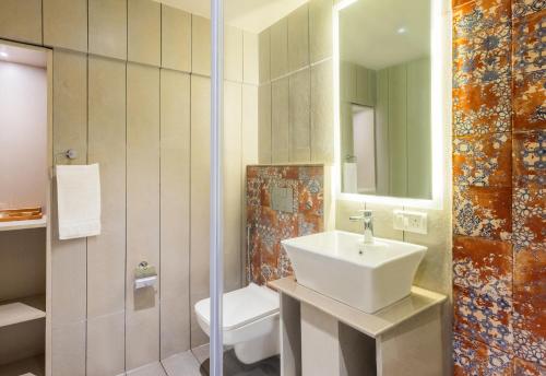 a bathroom with a sink and a toilet at Goan Bliss in Varca
