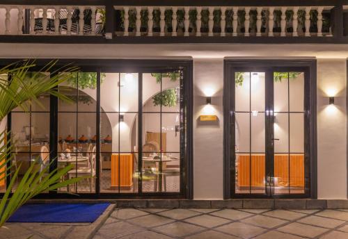 a facade of a house with glass doors at Goan Bliss in Varca