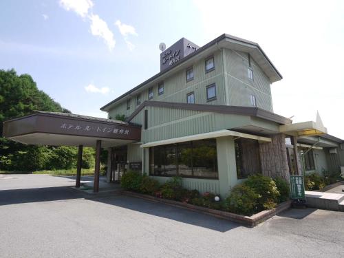 a building with a sign in front of it at Hotel Route-Inn Court Karuizawa in Miyota