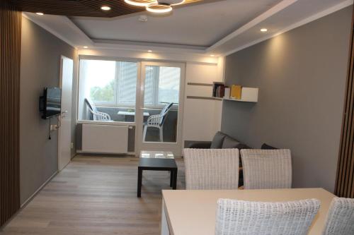 a living room with a couch and chairs and a table at Ferienwohnung Ostsee F414 in Schönberg in Holstein