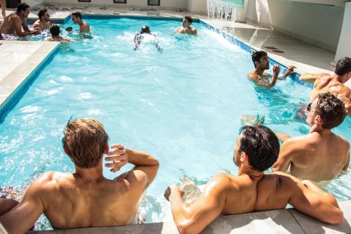 a group of men sitting in a swimming pool at The Glen Boutique Hotel & Spa in Cape Town