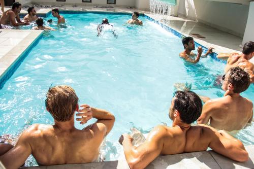 
two boys are playing in a pool together at The Glen Boutique Hotel & Spa in Cape Town
