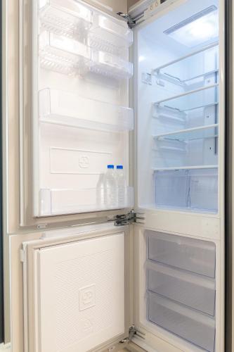 an open refrigerator with bottles of water in it at Hotel Wavellent Yangyang in Yangyang