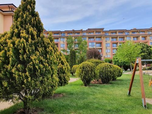 a large building with trees in front of a building at Magic Dreams Apartments in Sveti Vlas