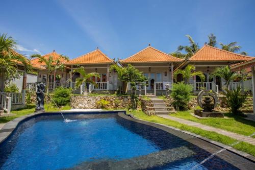 a house with a swimming pool in front of it at Blue Sky Villa Ceningan in Nusa Lembongan