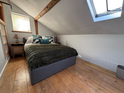 a bedroom with a bed in a attic at The old pub in Docking in Docking