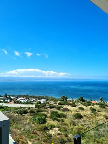 a view of the ocean from a house at View At The Bay in Mossel Bay