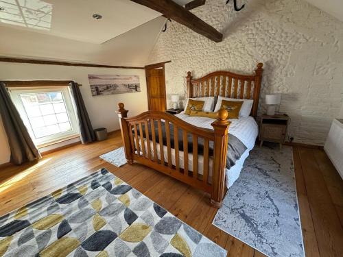 a bedroom with a wooden bed and a rug at The old pub in Docking in Docking