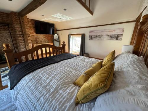 a bedroom with a large bed with pillows on it at The old pub in Docking in Docking