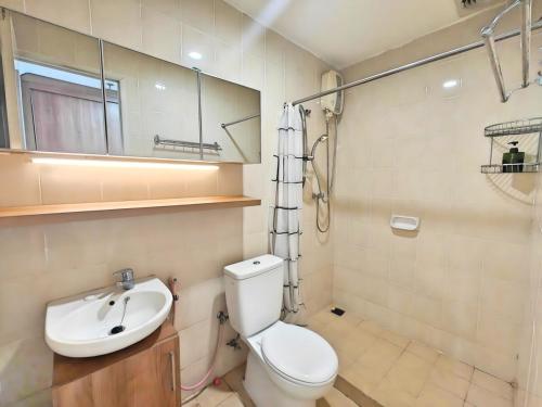 a bathroom with a toilet and a sink at Strategic 3BR Sudirman Park Apt with Wi-Fi, Pool,Gym by 2ndHome in Jakarta