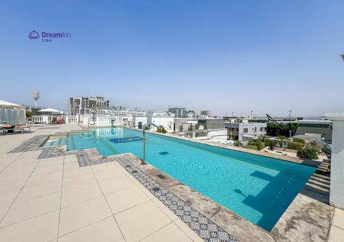 a swimming pool on the roof of a building at Dream Inn - Modern 1BR in Arjan in Dubai